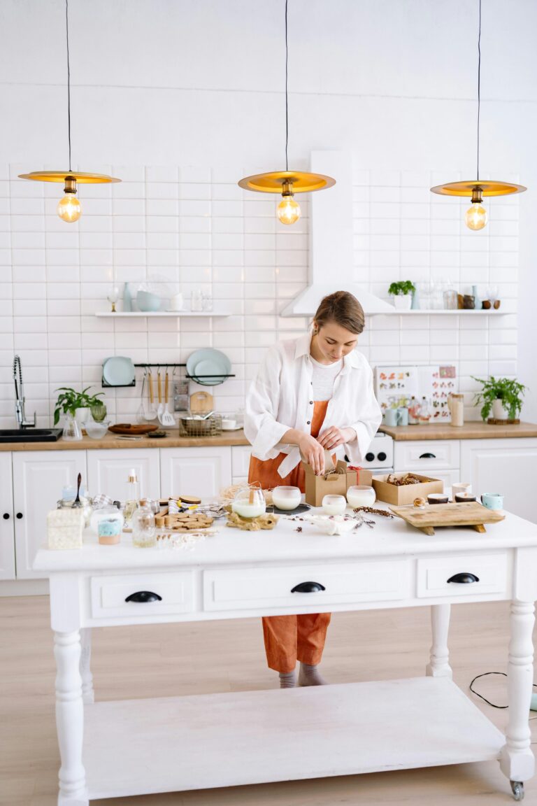 A young woman chef cooks in a stylish kitchen with bright lighting and elegant decor.