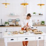 pexels-photo-7233933-7233933 A young woman chef cooks in a stylish kitchen with bright lighting and elegant decor.